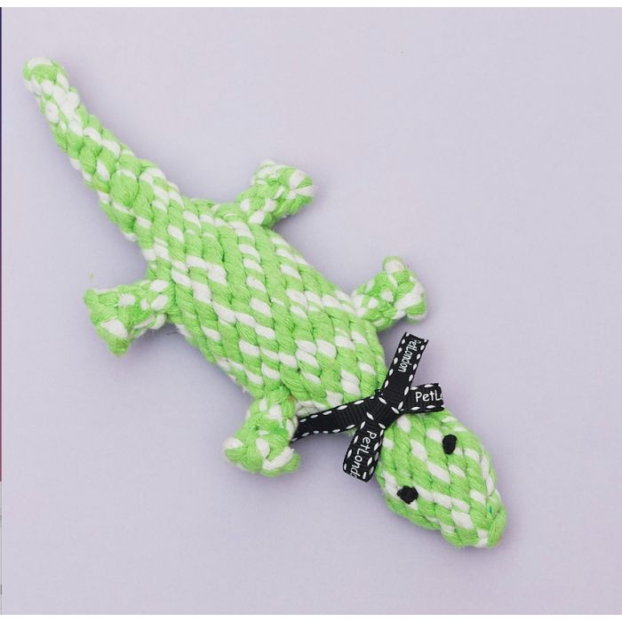 A lizard shaped dog toy on a purple background